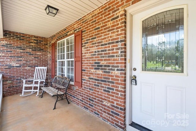 1011 Atherstone St NW, Conover, NC 28613 - doorway to property featuring a porch and brick siding