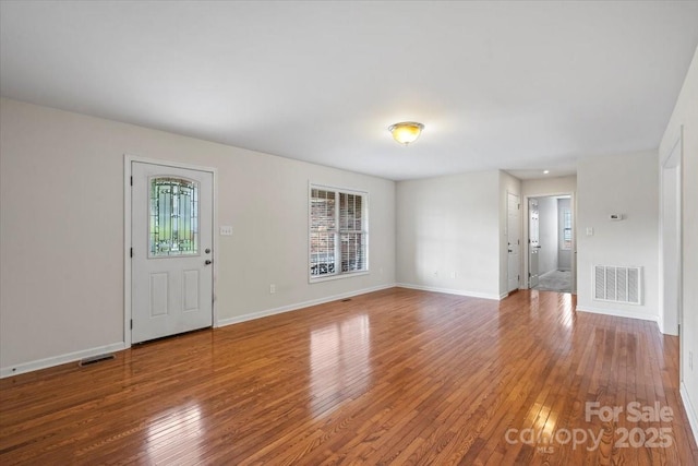 1011 Atherstone St NW, Conover, NC 28613 - unfurnished living room with hardwood / wood-style floors and baseboards