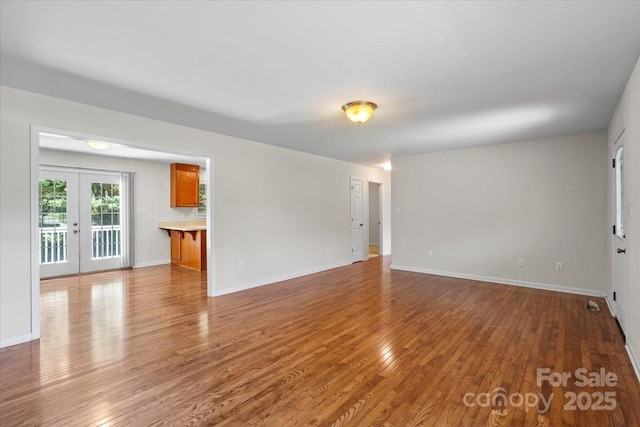 1011 Atherstone St NW, Conover, NC 28613 - unfurnished living room with wood finished floors and french doors