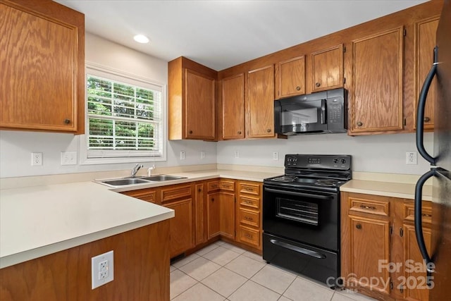 1011 Atherstone St NW, Conover, NC 28613 - kitchen with black appliances, brown cabinets, light tile patterned floors, light countertops, and recessed lighting
