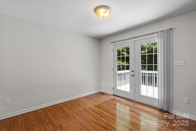 1011 Atherstone St NW, Conover, NC 28613 - empty room with french doors and wood finished floors