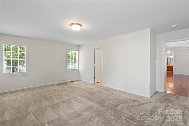 1011 Atherstone St NW, Conover, NC 28613 - empty room with healthy amount of natural light and light colored carpet