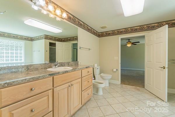 639 Panther Point Trl, Richfield, NC 28137 - full bath featuring a bidet, vanity, tile patterned flooring, and a ceiling fan