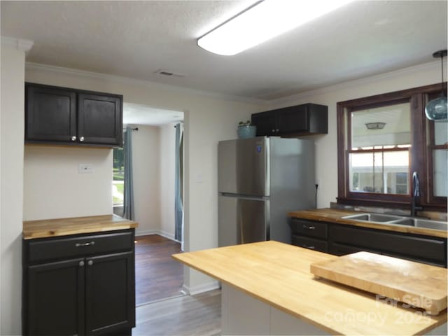820 Baldwin Ave, Marion, NC 28752 - kitchen with wood counters, freestanding refrigerator, plenty of natural light, dark wood-type flooring, and ornamental molding