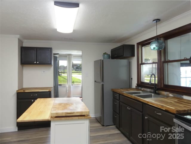 820 Baldwin Ave, Marion, NC 28752 - kitchen featuring butcher block counters, light wood-style floors, crown molding, and healthy amount of natural light