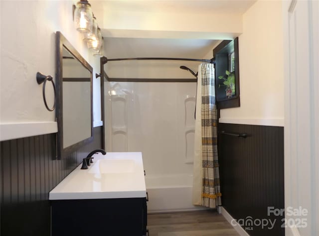 820 Baldwin Ave, Marion, NC 28752 - full bathroom with vanity, wood finished floors, shower / bathtub combination with curtain, and wainscoting