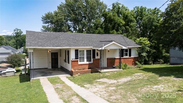 820 Baldwin Ave, Marion, NC 28752 - bungalow-style home featuring driveway, brick siding, a front yard, an attached carport, and a shingled roof