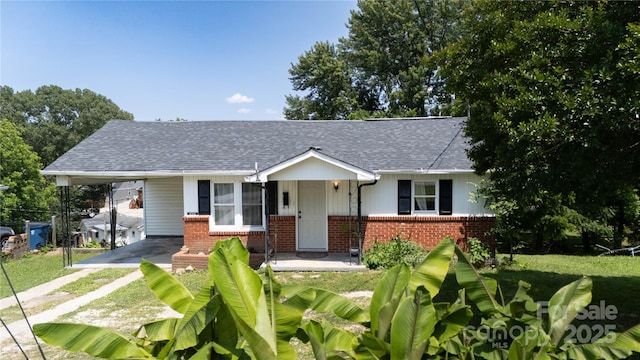 820 Baldwin Ave, Marion, NC 28752 - view of front of home featuring brick siding, dirt driveway, a carport, and a shingled roof