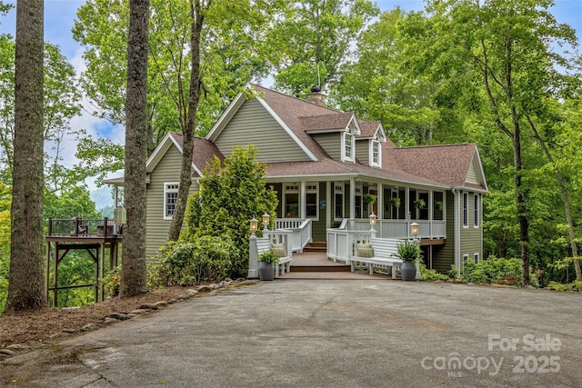 1987 Rabbit Hop Rd, Spruce Pine, NC 28777 - view of front of home featuring covered porch, a shingled roof, and a chimney