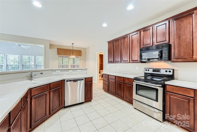 1220 Elrond Dr NW, Charlotte, NC 28269 - kitchen with appliances with stainless steel finishes, light countertops, ceiling fan, light tile patterned flooring, and recessed lighting