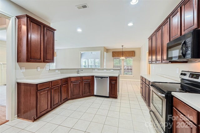 1220 Elrond Dr NW, Charlotte, NC 28269 - kitchen featuring appliances with stainless steel finishes, light countertops, a peninsula, light tile patterned floors, and recessed lighting