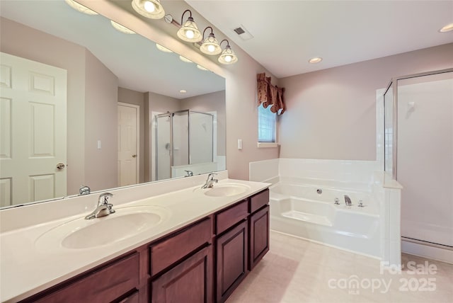 1220 Elrond Dr NW, Charlotte, NC 28269 - full bathroom with a shower stall, a garden tub, double vanity, tile patterned flooring, and recessed lighting
