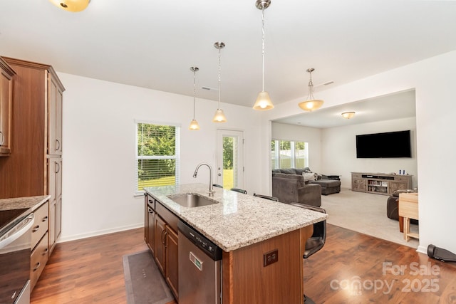 1691 Ashley Lynn Ct, Stanfield, NC 28163 - kitchen with appliances with stainless steel finishes, a kitchen island with sink, dark wood-style floors, a breakfast bar area, and hanging light fixtures