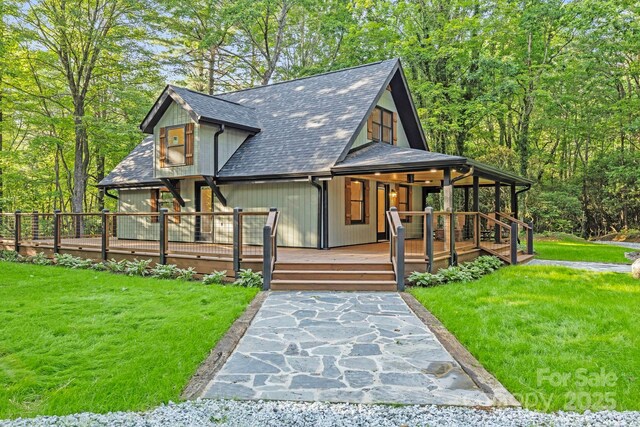327 Flat Ridge Dr, Lake Toxaway, NC 28774 - view of front facade with a front lawn and roof with shingles