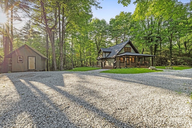 327 Flat Ridge Dr, Lake Toxaway, NC 28774 - view of home's exterior featuring a porch, driveway, and a storage unit