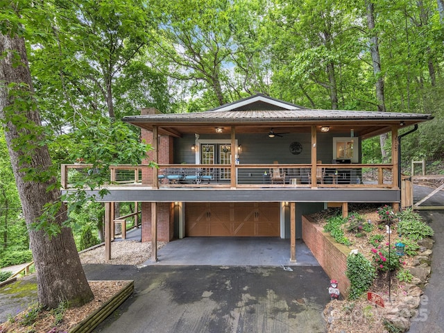 505 Scenic Cir, Waynesville, NC 28786 - view of front of house featuring asphalt driveway, an attached garage, and a metal roof