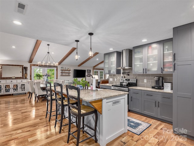 505 Scenic Cir, Waynesville, NC 28786 - kitchen with wall chimney exhaust hood, stainless steel electric range oven, gray cabinetry, light wood-type flooring, and glass insert cabinets