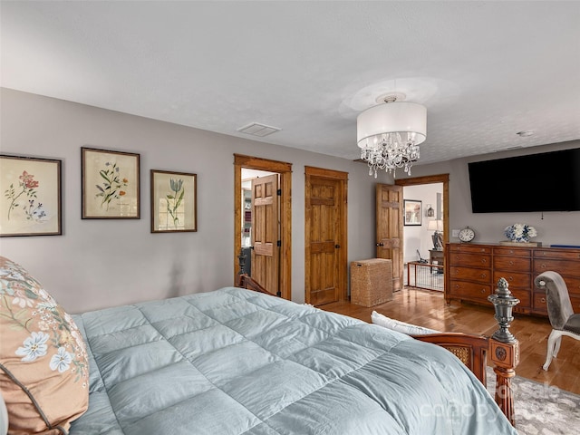 505 Scenic Cir, Waynesville, NC 28786 - bedroom with wood finished floors and a chandelier