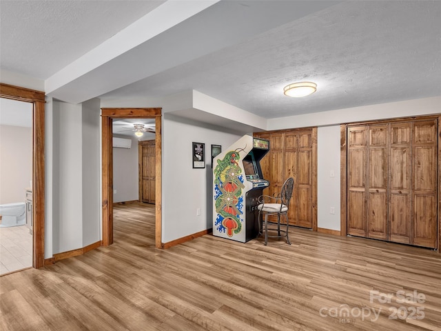 505 Scenic Cir, Waynesville, NC 28786 - entryway with light wood-style floors, a textured ceiling, a wall mounted air conditioner, and ceiling fan