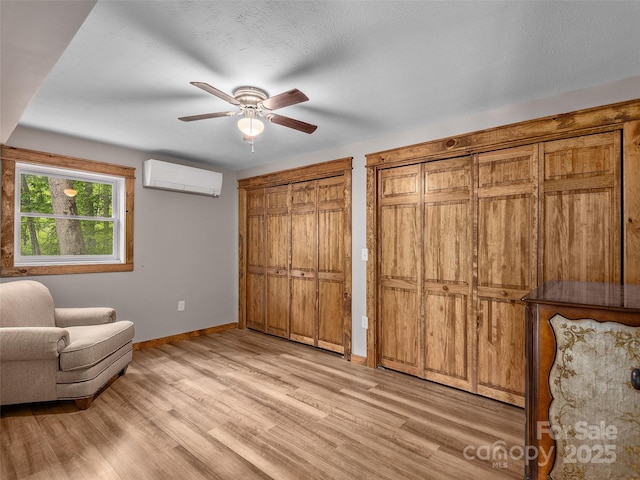 505 Scenic Cir, Waynesville, NC 28786 - sitting room featuring a wall unit AC, light wood-type flooring, and ceiling fan
