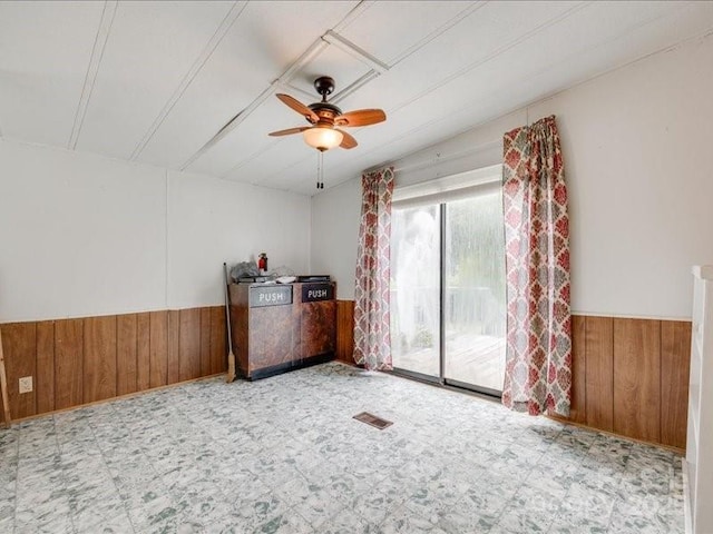 1406 Old Puckett Pl Unit 14, York, SC 29745 - unfurnished room featuring wood walls, wainscoting, a ceiling fan, and tile patterned floors