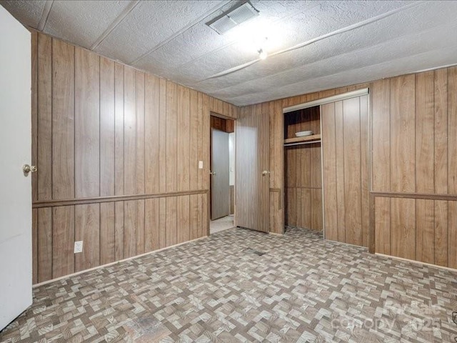 1406 Old Puckett Pl Unit 14, York, SC 29745 - unfurnished bedroom featuring wooden walls, a closet, and parquet floors