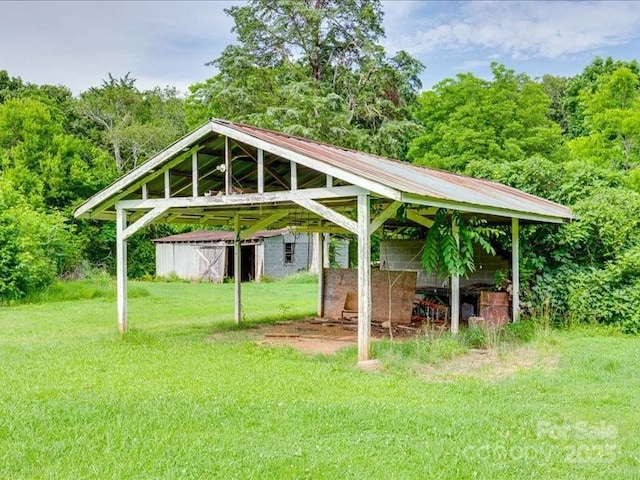 1406 Old Puckett Pl Unit 14, York, SC 29745 - view of green lawn with a carport, an outdoor structure, and a view of trees