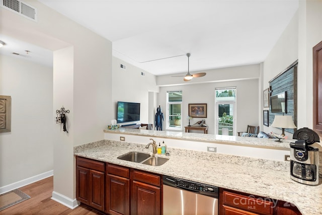 1315 E Blvd Unit 203, Charlotte, NC 28203 - kitchen featuring stainless steel dishwasher, light wood-type flooring, light stone counters, and open floor plan