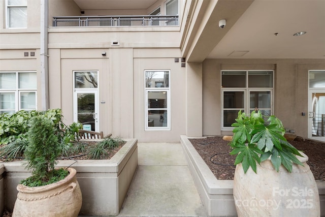1315 E Blvd Unit 203, Charlotte, NC 28203 - view of exterior entry featuring a balcony and stucco siding