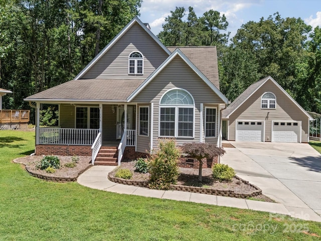 179 Delwood Ct, Mount Gilead, NC 27371 - view of front of home featuring covered porch, a garage, a front yard, an outbuilding, and concrete driveway