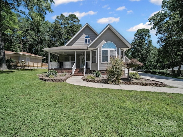 179 Delwood Ct, Mount Gilead, NC 27371 - view of front facade with a porch, a front lawn, and concrete driveway