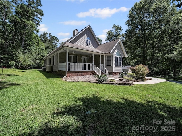 179 Delwood Ct, Mount Gilead, NC 27371 - rear view of house with a porch, a chimney, and a lawn