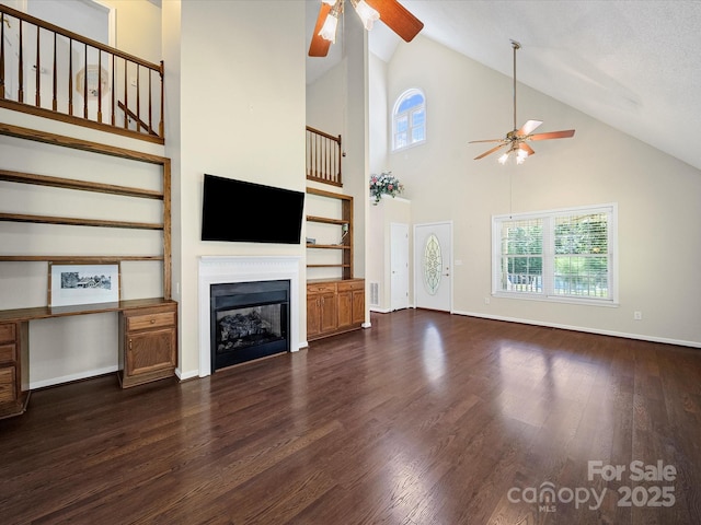 179 Delwood Ct, Mount Gilead, NC 27371 - unfurnished living room featuring ceiling fan, a fireplace, dark wood-type flooring, and high vaulted ceiling
