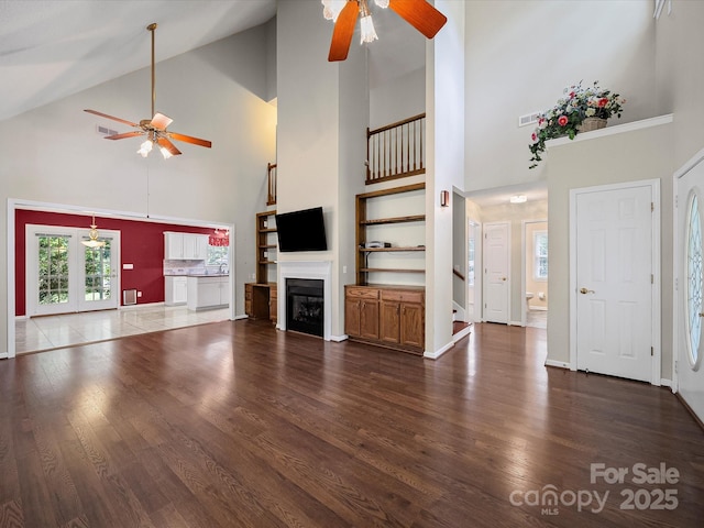179 Delwood Ct, Mount Gilead, NC 27371 - unfurnished living room with a ceiling fan, high vaulted ceiling, wood finished floors, and a fireplace
