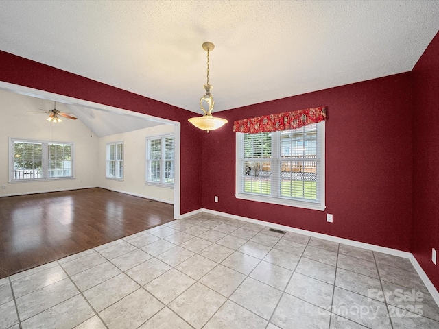 179 Delwood Ct, Mount Gilead, NC 27371 - tiled spare room featuring healthy amount of natural light, lofted ceiling, ceiling fan, and a textured ceiling