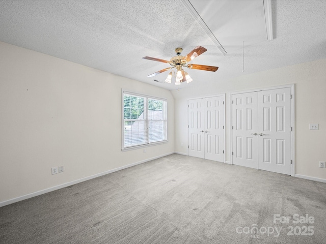 179 Delwood Ct, Mount Gilead, NC 27371 - unfurnished bedroom featuring attic access, two closets, a textured ceiling, carpet floors, and ceiling fan