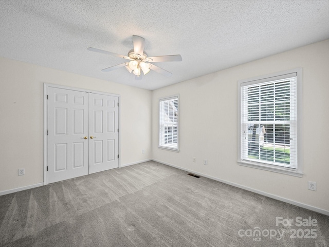 179 Delwood Ct, Mount Gilead, NC 27371 - unfurnished bedroom with carpet, a textured ceiling, a closet, and ceiling fan