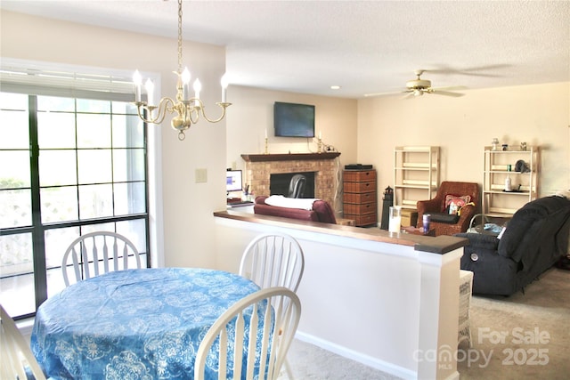 5864 Harris Grove Ln, Charlotte, NC 28212 - dining space featuring carpet flooring, ceiling fan, a chandelier, a brick fireplace, and a textured ceiling
