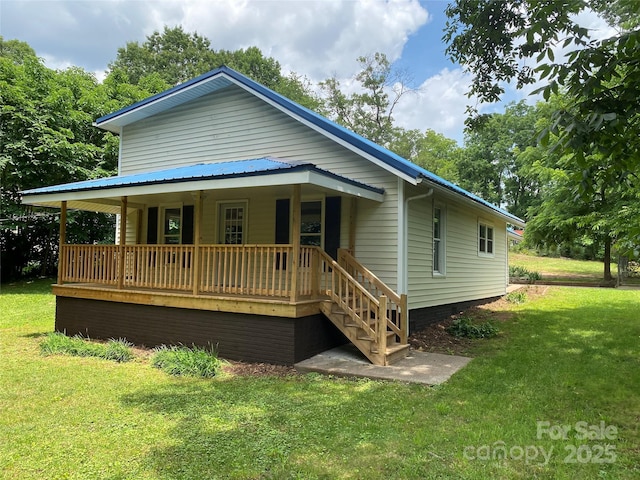 103 Hickory Hills Dr, Morganton, NC 28655 - back of property featuring covered porch and a lawn