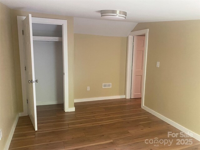 103 Hickory Hills Dr, Morganton, NC 28655 - unfurnished bedroom with dark wood finished floors, a closet, and vaulted ceiling