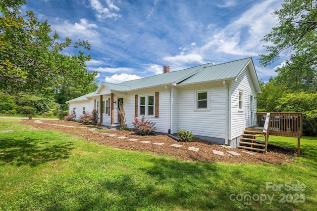 110 Camelot Dr, Granite Falls, NC 28630 - view of front of home with a front lawn, a chimney, a deck, and a metal roof