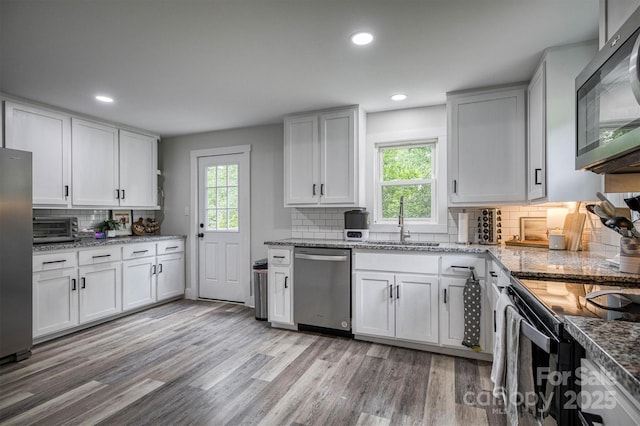 110 Camelot Dr, Granite Falls, NC 28630 - kitchen with appliances with stainless steel finishes, plenty of natural light, backsplash, light wood-style flooring, and recessed lighting