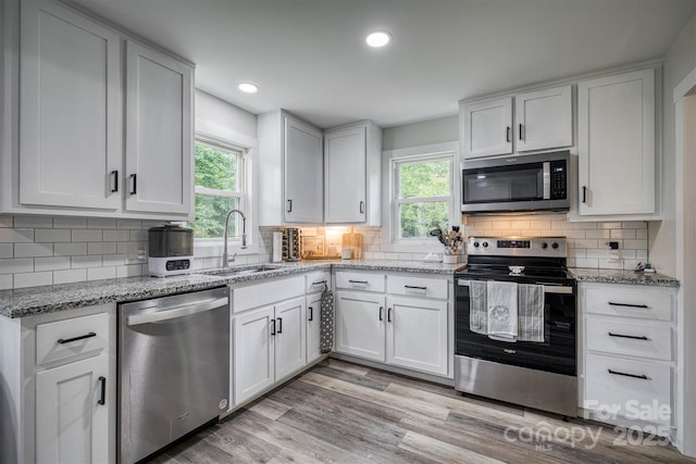 110 Camelot Dr, Granite Falls, NC 28630 - kitchen with stainless steel appliances, plenty of natural light, white cabinetry, light stone countertops, and recessed lighting