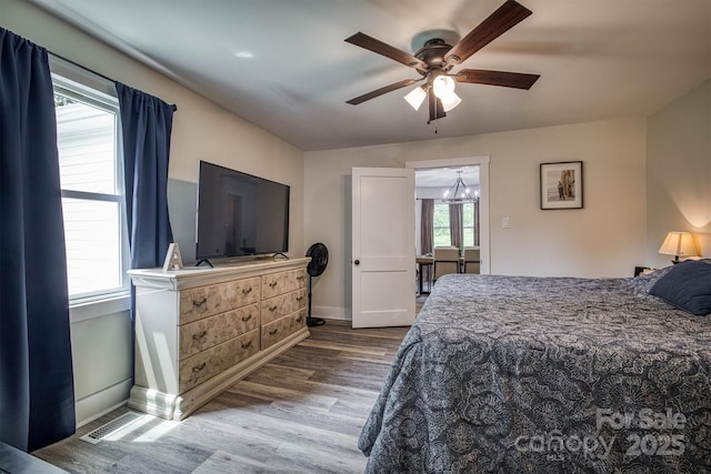 110 Camelot Dr, Granite Falls, NC 28630 - bedroom with wood finished floors, ceiling fan, and a chandelier