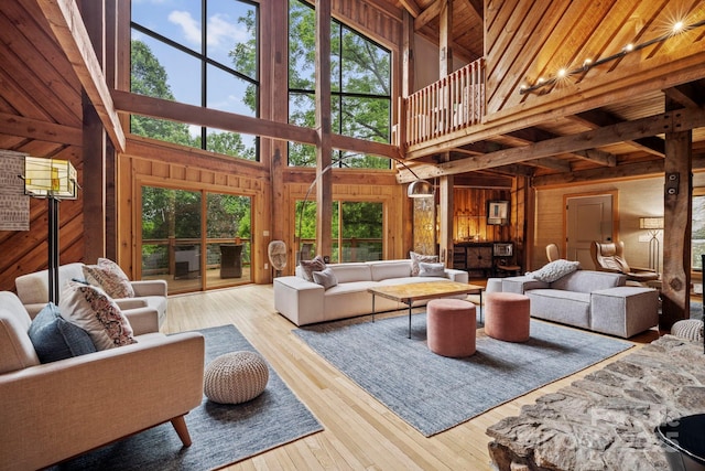 574 Locust Grove Dr, Waynesville, NC 28785 - living area with wood walls, a high ceiling, hardwood / wood-style flooring, and beam ceiling