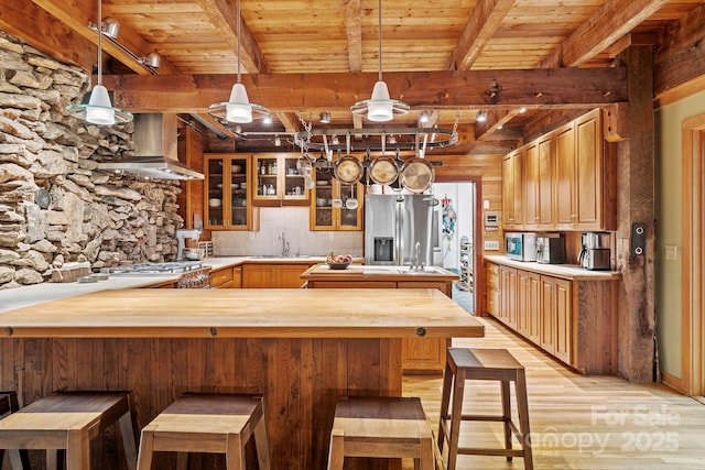 574 Locust Grove Dr, Waynesville, NC 28785 - kitchen featuring appliances with stainless steel finishes, wall chimney range hood, light wood finished floors, a peninsula, and butcher block countertops