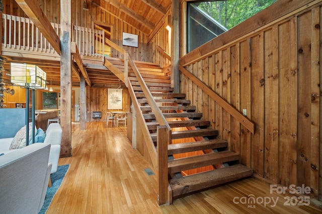 574 Locust Grove Dr, Waynesville, NC 28785 - stairway with wooden walls, hardwood / wood-style floors, high vaulted ceiling, and a wooden ceiling with exposed beams