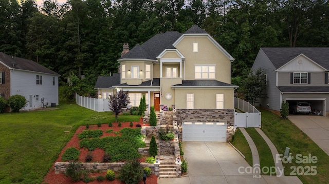 2117 Middlebridge Ct, Fort Mill, SC 29715 - traditional home featuring stucco siding, stairway, concrete driveway, a garage, and a chimney