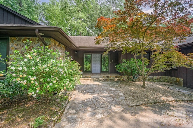 3041 Shallowood Ln, Charlotte, NC 28277 - doorway to property featuring stone siding and board and batten siding