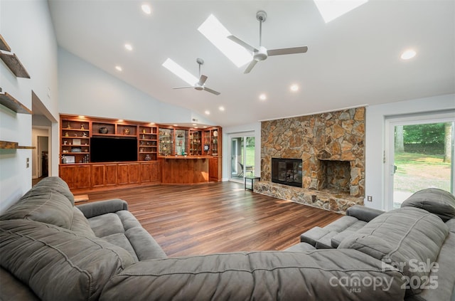 3041 Shallowood Ln, Charlotte, NC 28277 - living room with ceiling fan, a skylight, high vaulted ceiling, wood finished floors, and a stone fireplace